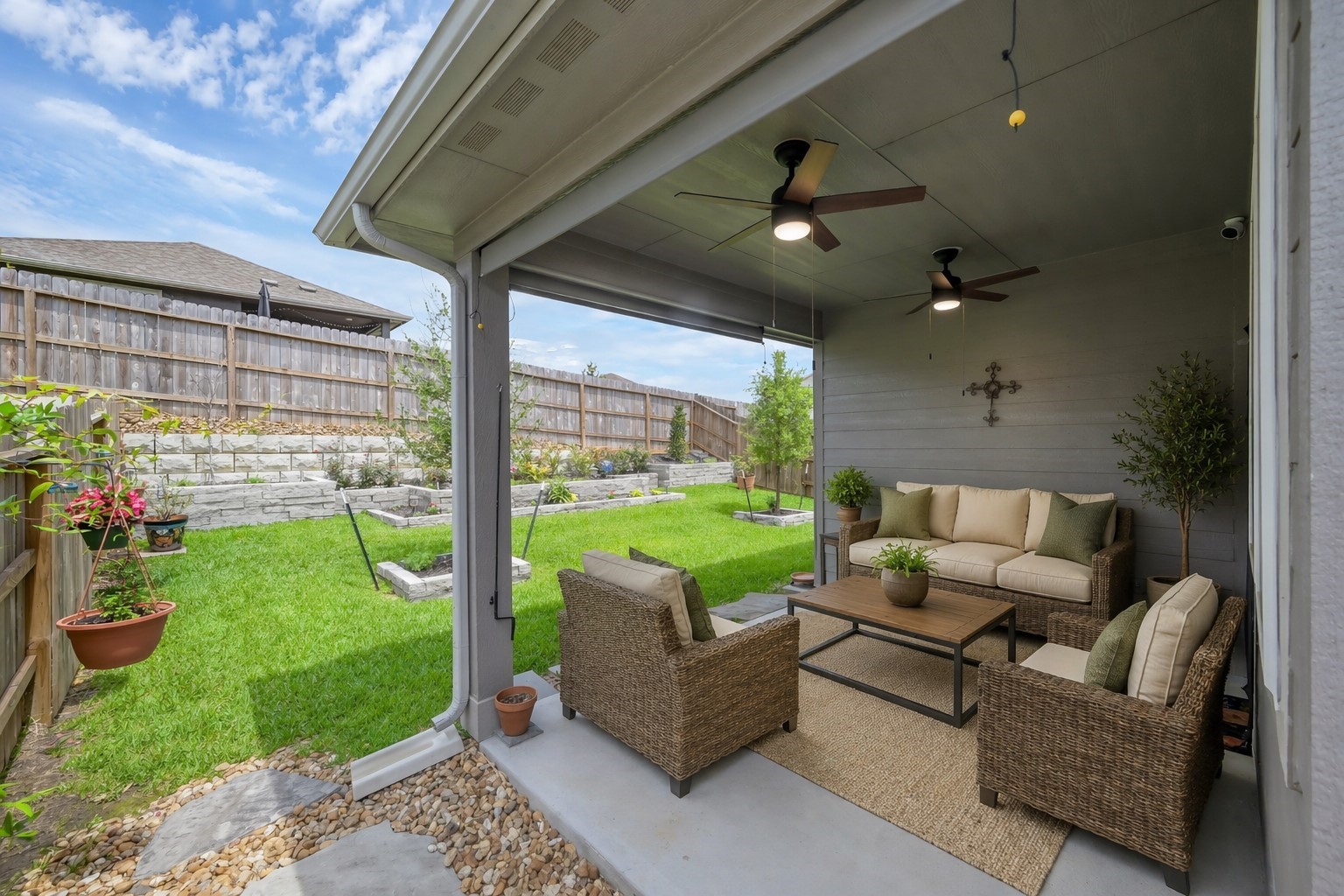 372 Sunrise Rnch Drive Montgomery, TX 77316 - Photo 20 of 32 Your covered porch overlooking a neatly kept backyard with dual ceiling fans, sunshades, and meticulously landscaped garden beds.