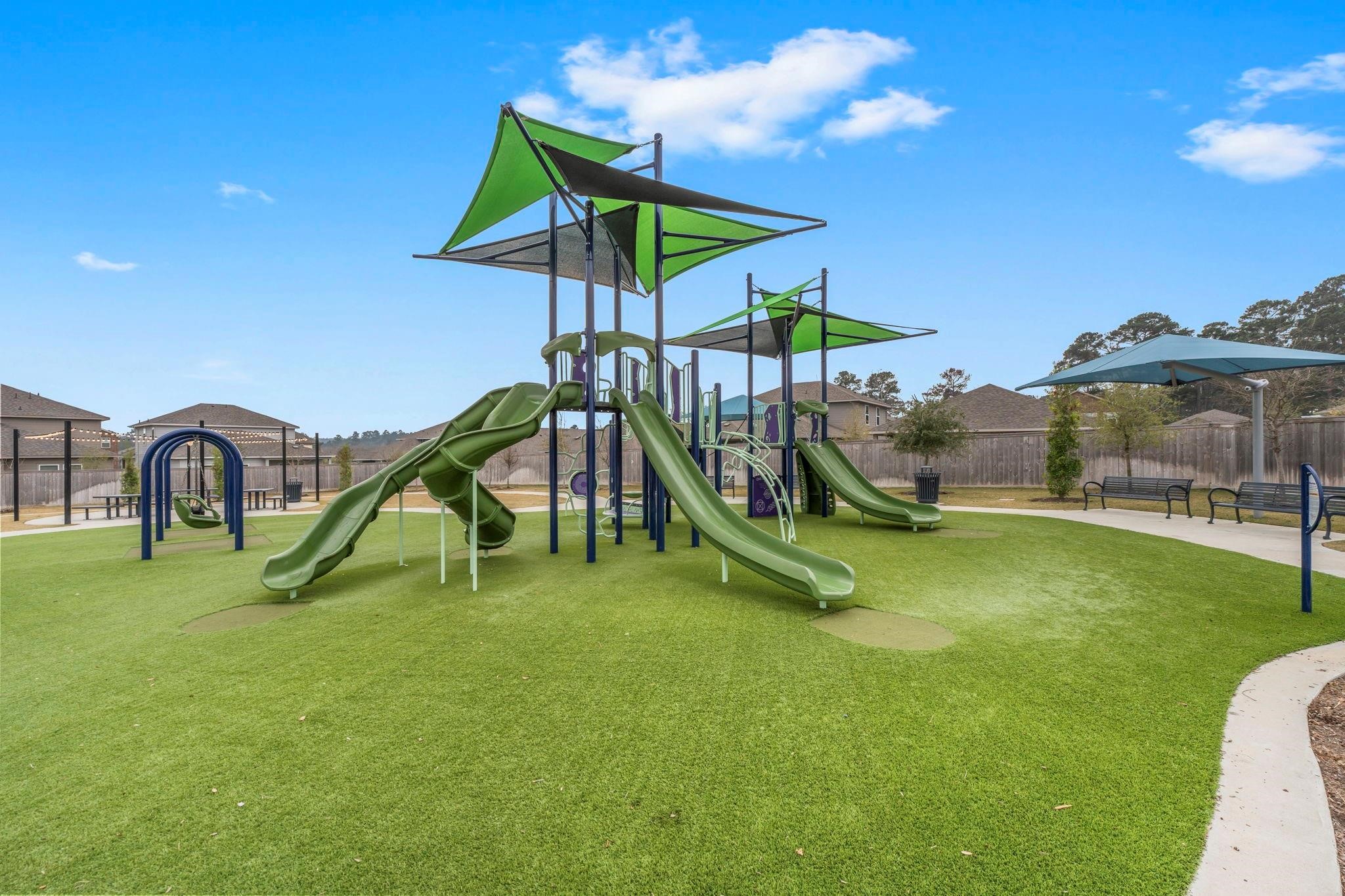 372 Sunrise Rnch Drive Montgomery, TX 77316 - Photo 24 of 32 Also available is a well-maintained playground with green slides and shaded structures, offering a family-friendly environment.