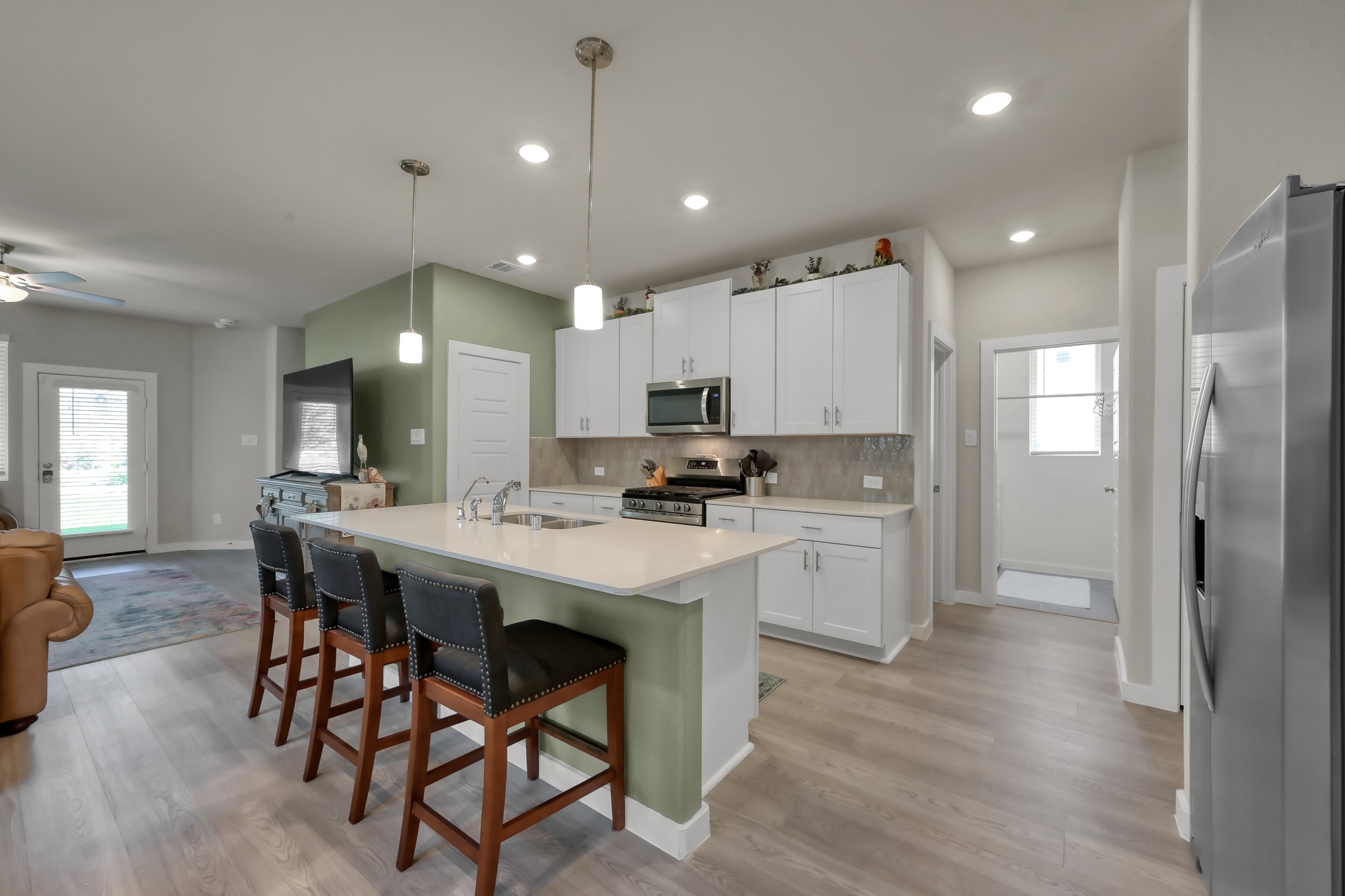 372 Sunrise Rnch Drive Montgomery, TX 77316 - Photo 5 of 32 The space opens to a cozy living area with access to a patio through glass doors.