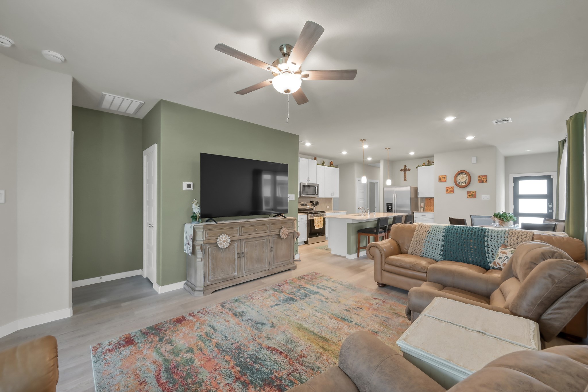 372 Sunrise Rnch Drive Montgomery, TX 77316 - Photo 6 of 32 This inviting open-concept living area features a comfortable seating arrangement. The space is well-lit with contemporary fixtures and provides warmth and character.