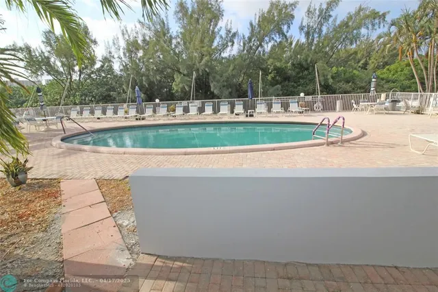 a view of a swimming pool with a yard