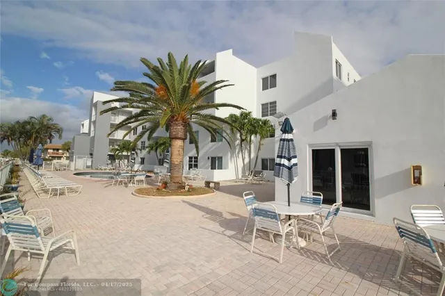 a view of a patio with a dining table and chairs