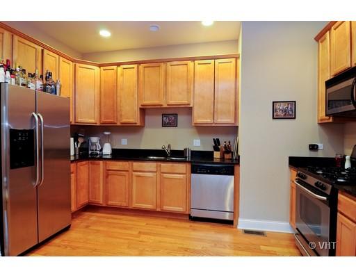 3357 North Seminary Avenue, Unit 1 Chicago, IL 60657 - Photo 3 of 10 a kitchen with stainless steel appliances granite countertop a stove a sink and a refrigerator