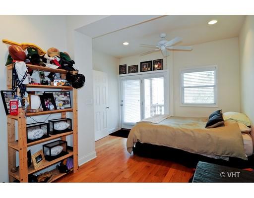 3357 North Seminary Avenue, Unit 1 Chicago, IL 60657 - Photo 6 of 10 a bedroom with a bed a dresser and a book shelf