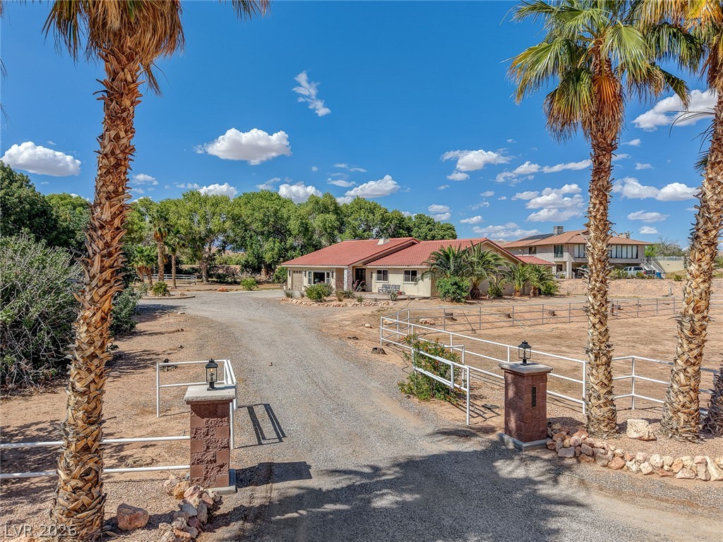 1950 Bowman Road Logandale, NV 89021 - Photo 70 of 81 Enter through grand palm-lined gates to a private, fenced estate with ample outdoor space.