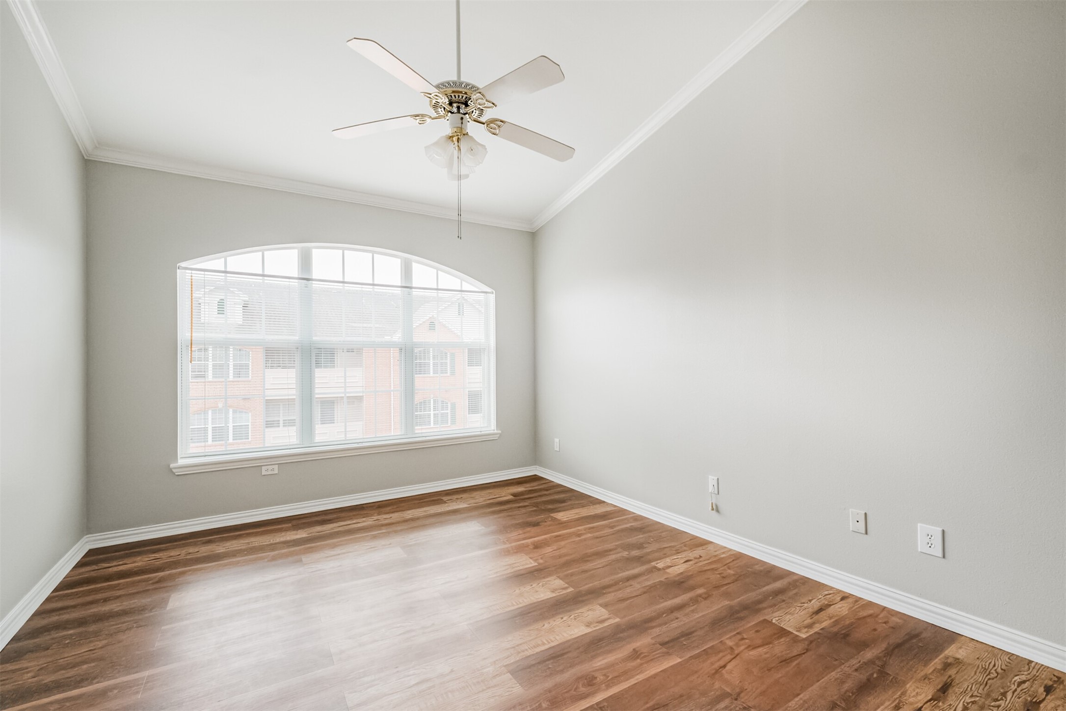 2111 Welch Street, Unit B304 Houston, TX 77019 - Photo 18 of 37 an empty room with wooden floor chandelier fan and windows
