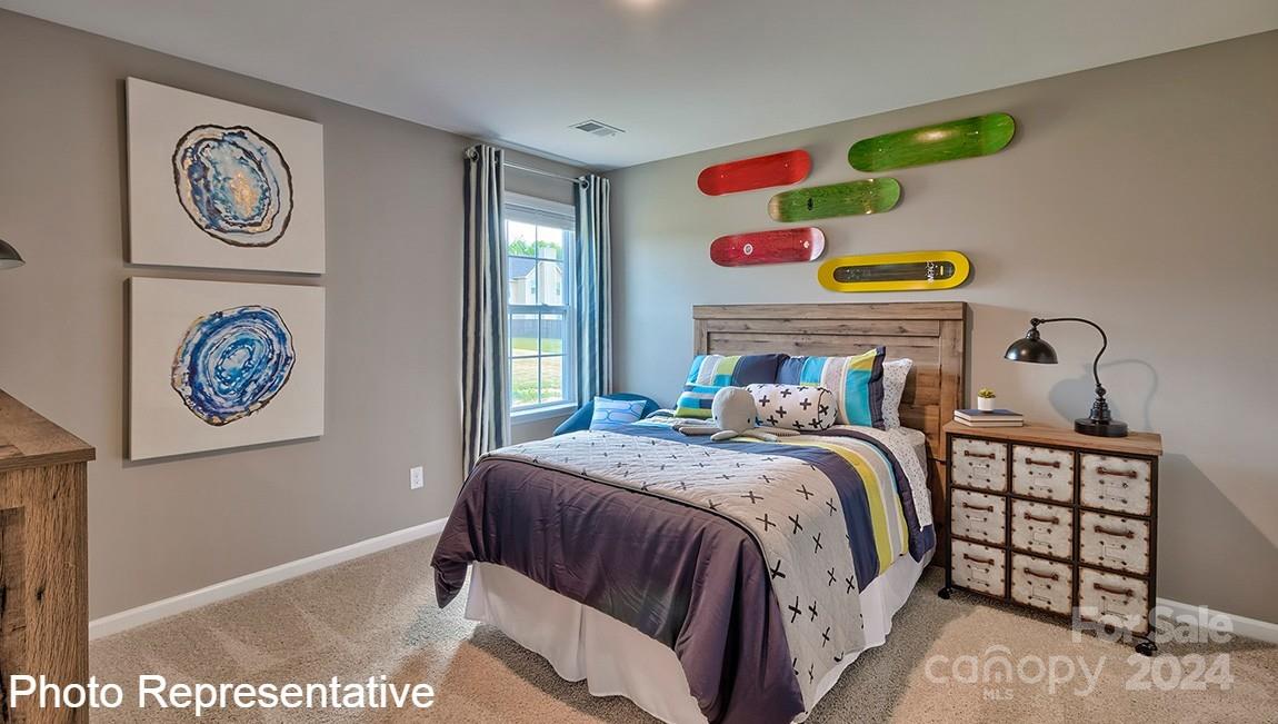 134 Dandelion Road Fletcher, NC 28732 - Photo 25 of 29 a bedroom with a bed and painting on the wall