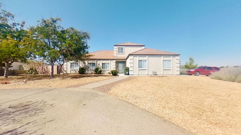 9574 Riggins Road Phelan, CA 92371 - Photo 1 of 1 a front view of a house with a yard