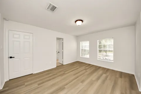 a bedroom with a bed and cabinets