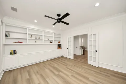 a living room with hard wood floors and white walls