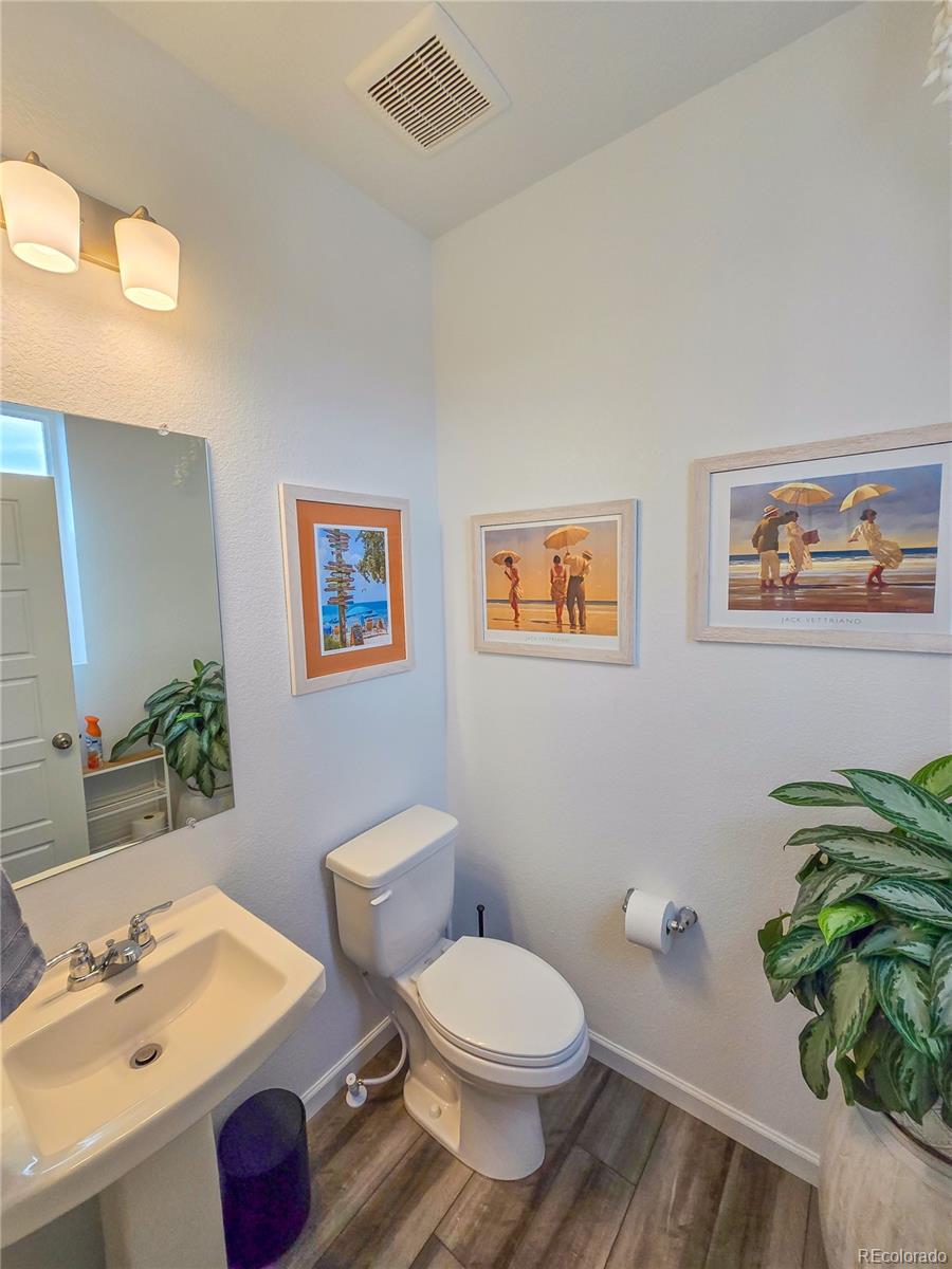 2084 Chambers Road Brighton, CO 80601 - Photo 11 of 50 a bathroom with a toilet sink and mirror