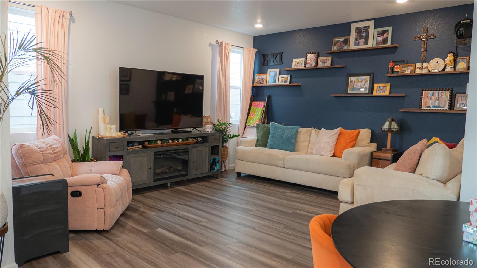 2084 Chambers Road Brighton, CO 80601 - Photo 14 of 50 a living room with furniture and a flat screen tv
