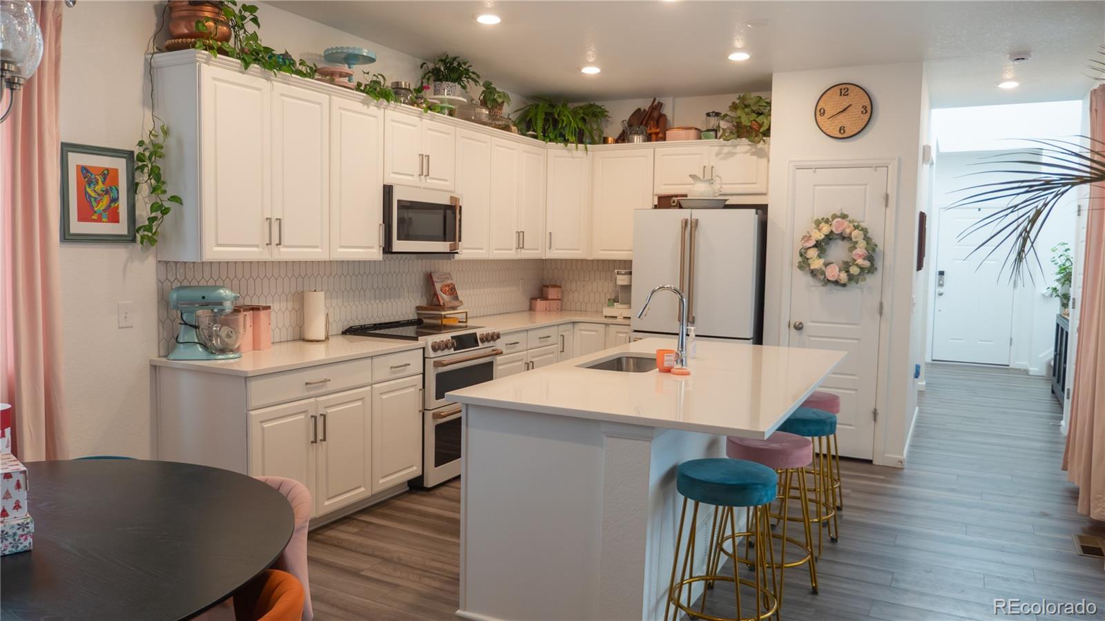 2084 Chambers Road Brighton, CO 80601 - Photo 22 of 50 a kitchen with a sink a refrigerator and a stove