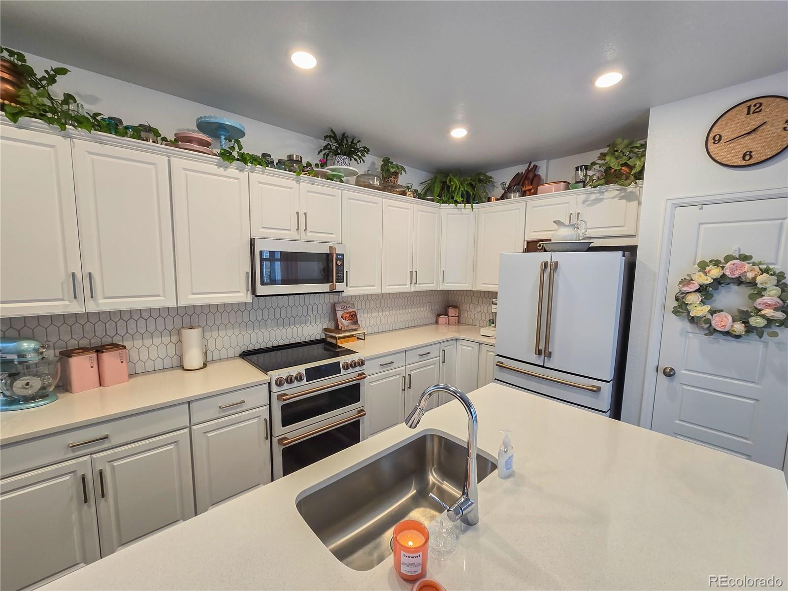 2084 Chambers Road Brighton, CO 80601 - Photo 23 of 50 a kitchen with a sink appliances and cabinets