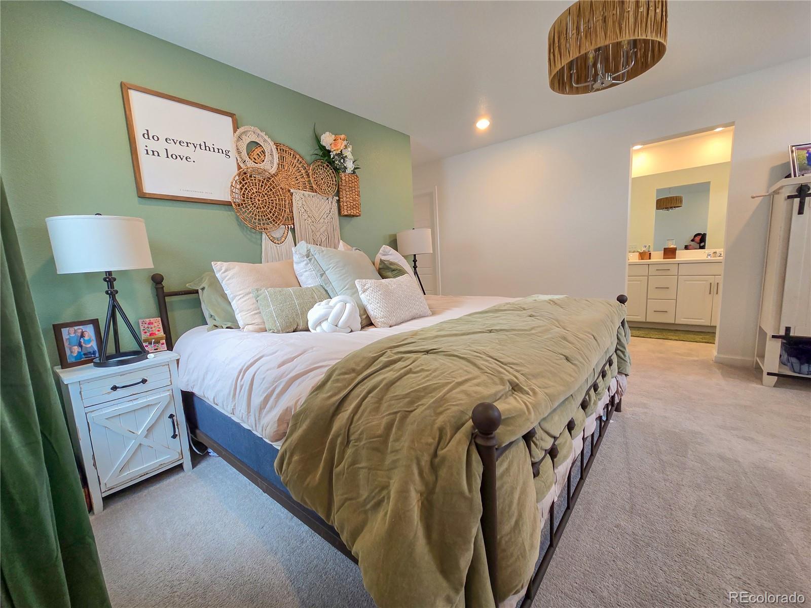 2084 Chambers Road Brighton, CO 80601 - Photo 27 of 50 a spacious bedroom with a bed and a lamp