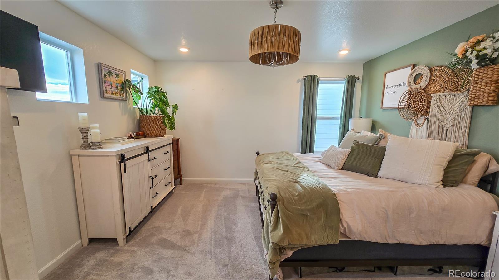 2084 Chambers Road Brighton, CO 80601 - Photo 29 of 50 a bed room with a bed window and a chandelier