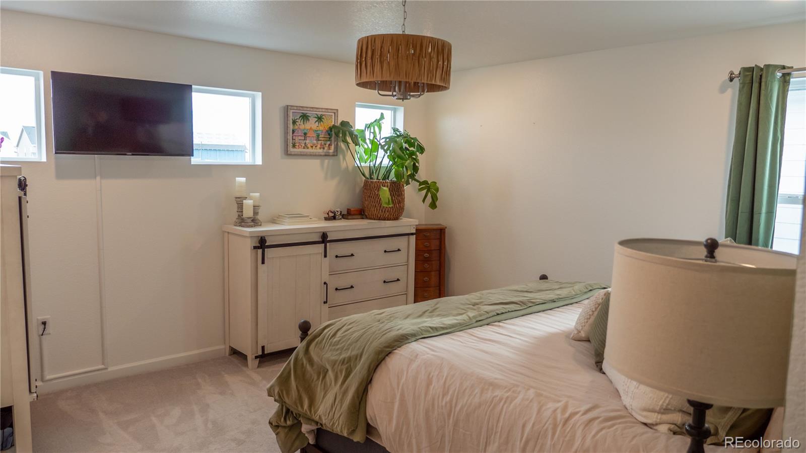 2084 Chambers Road Brighton, CO 80601 - Photo 31 of 50 a bedroom with a bed and a window