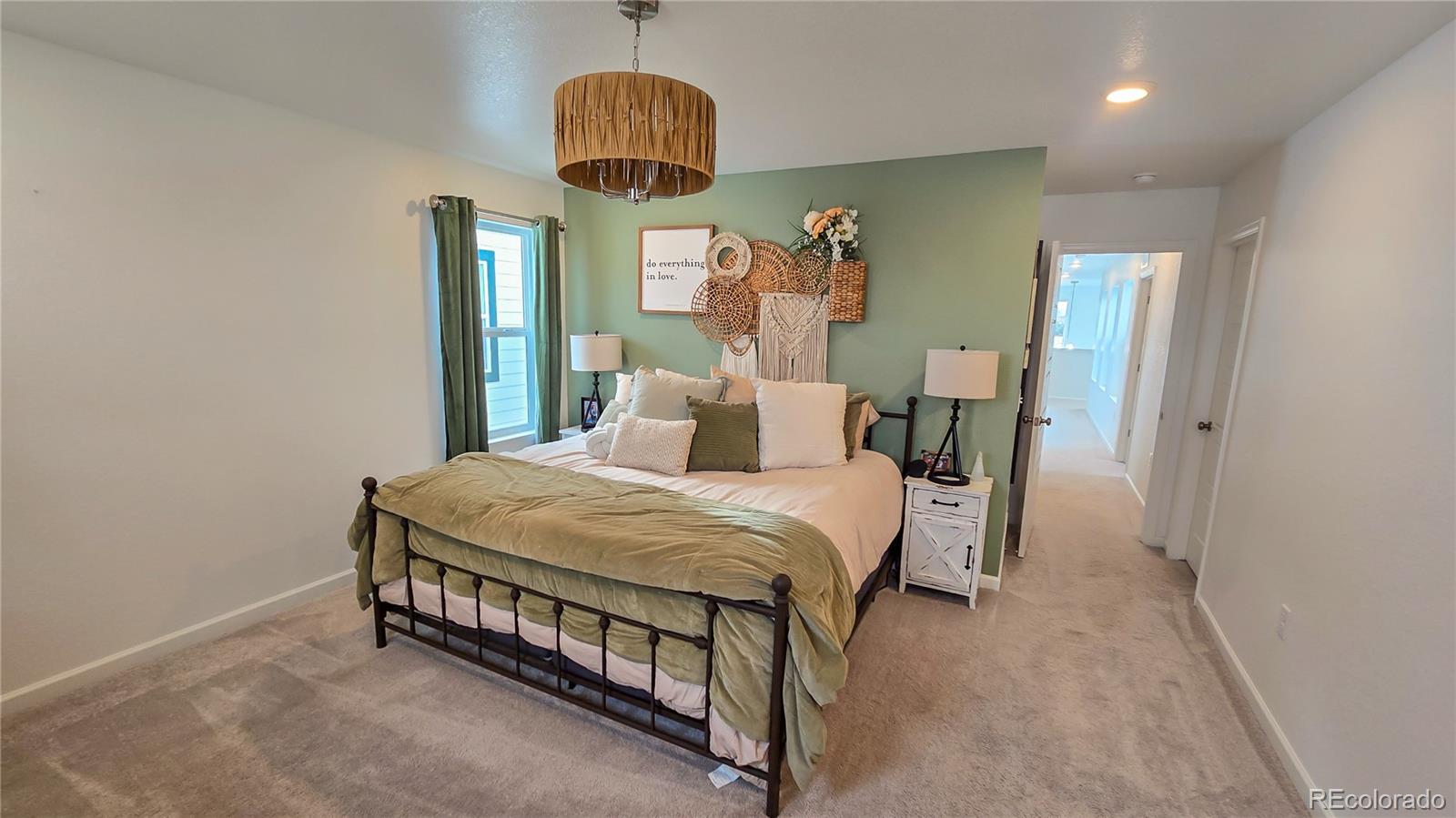 2084 Chambers Road Brighton, CO 80601 - Photo 32 of 50 a bed room with a bed and a chandelier