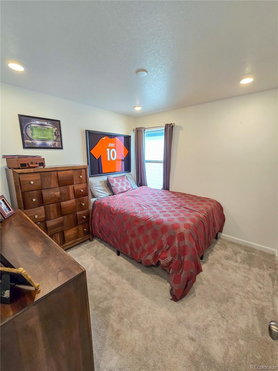 2084 Chambers Road Brighton, CO 80601 - Photo 41 of 50 a bedroom with bed and window