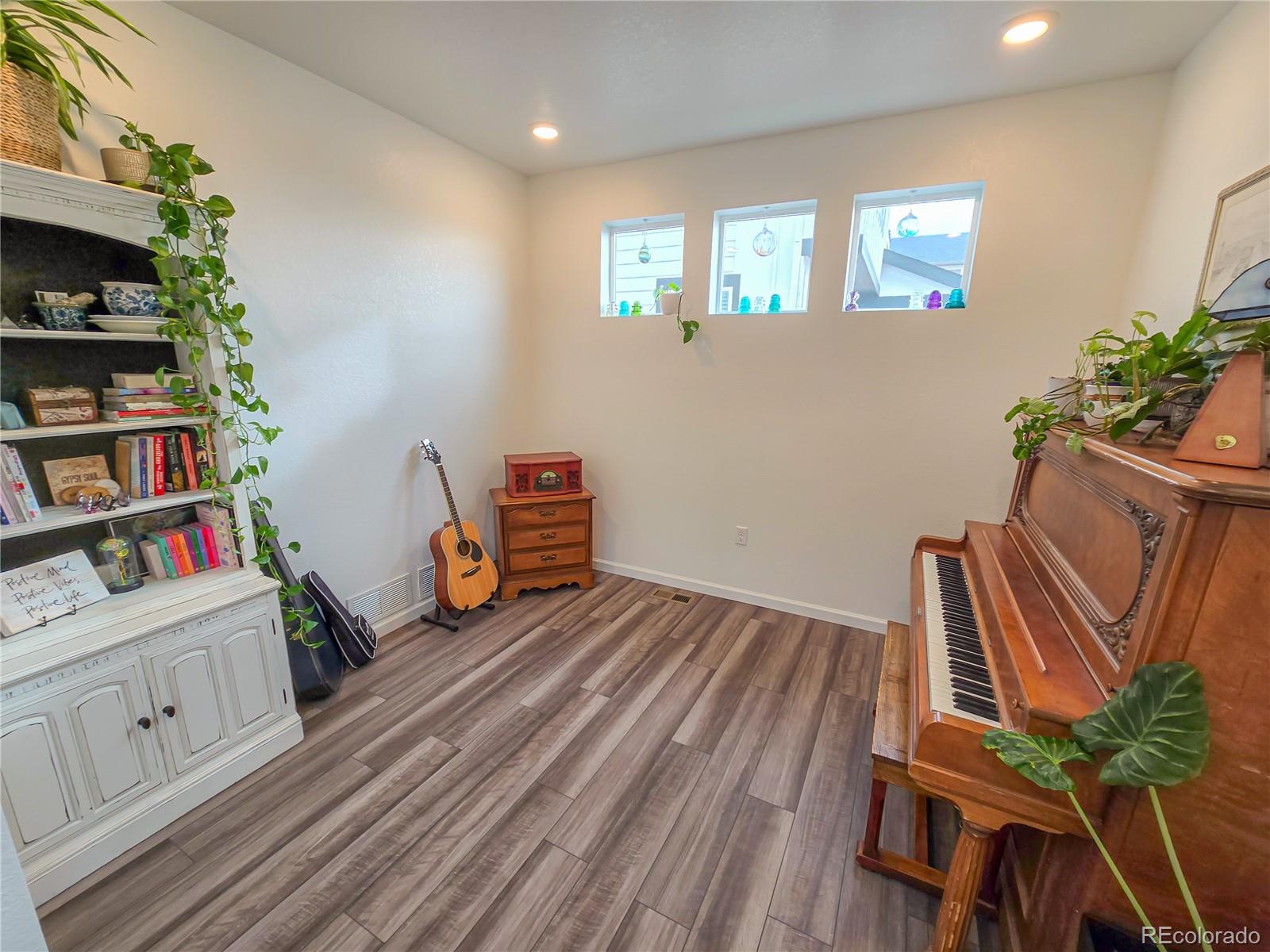 2084 Chambers Road Brighton, CO 80601 - Photo 10 of 50 a view of room with toys and wooden floor