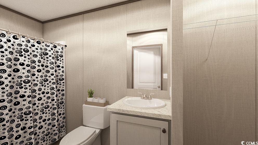 3733 Marvin Court Marion, SC 29571 - Photo 8 of 10 Full bathroom featuring vanity, curtained shower, and a textured ceiling