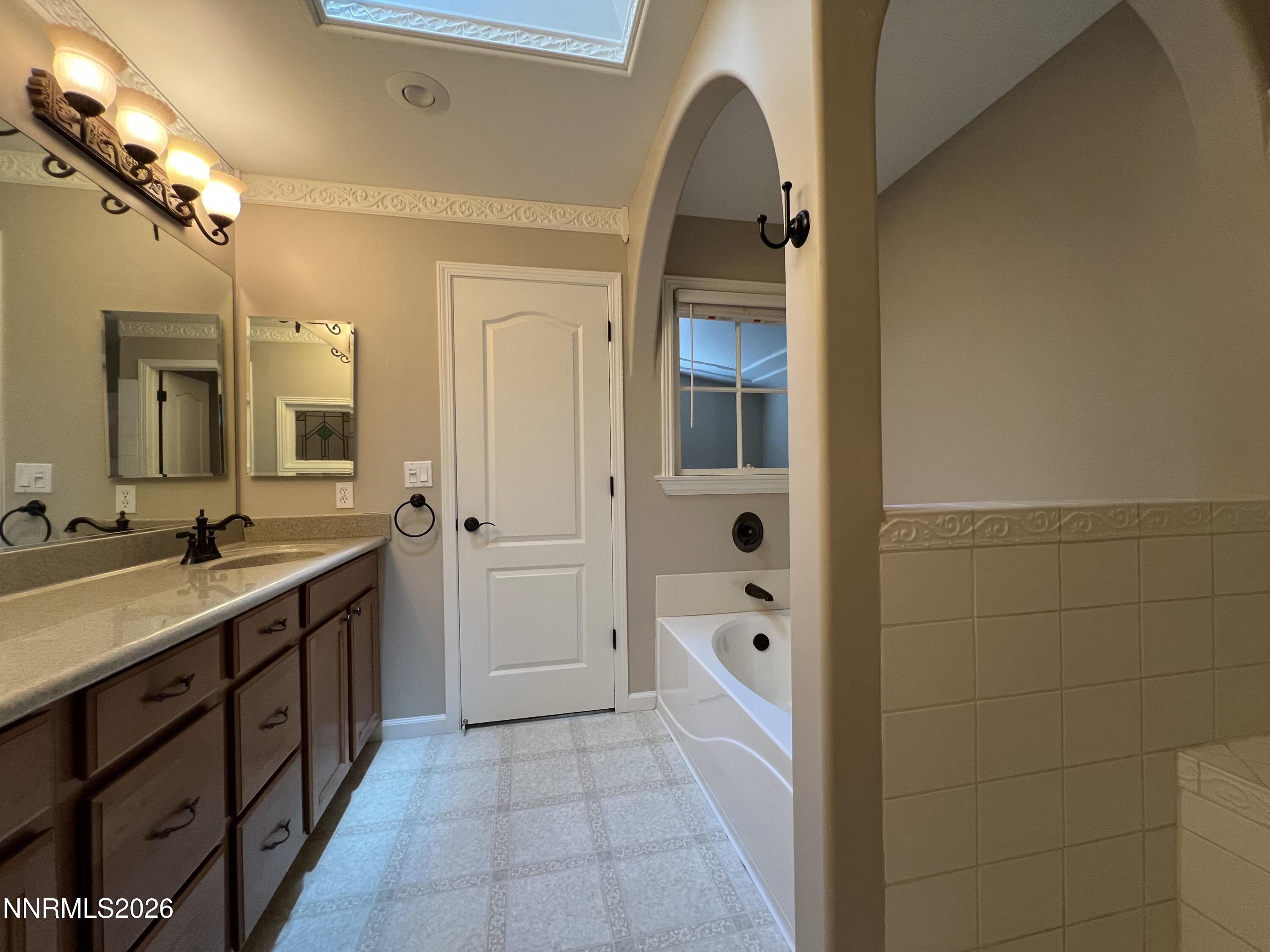 18406 Teddy Bear Court Reno, NV 89508 - Photo 19 of 44 a spacious bathroom with a granite countertop sink mirror and shower