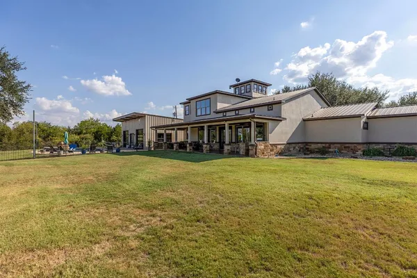 a view of a house with backyard and porch