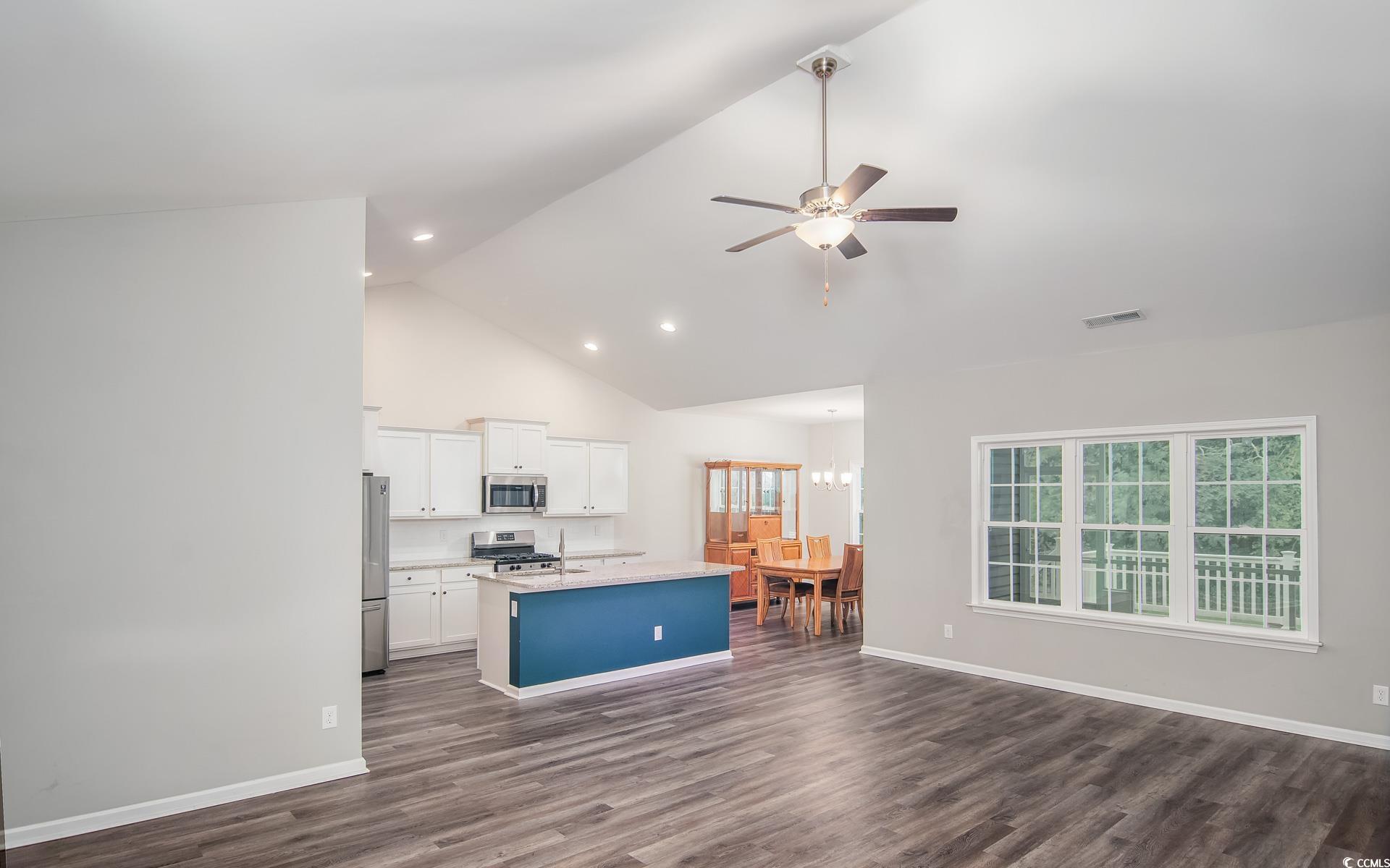 531 Charlton Boulevard Georgetown, SC 29440 - Photo 18 of 19 Kitchen with open floor plan, white cabinetry, an island with sink, high vaulted ceiling, and dark wood-type flooring