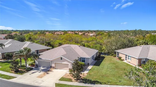 an aerial view of residential houses with outdoor space and street view