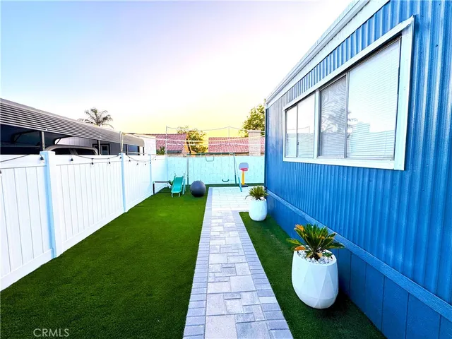 a front view of house along with deck and garden