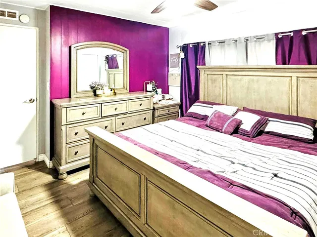 a bedroom with a bed and a mirror