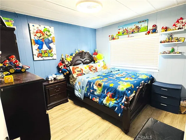 a bedroom with a bed and a dresser in it