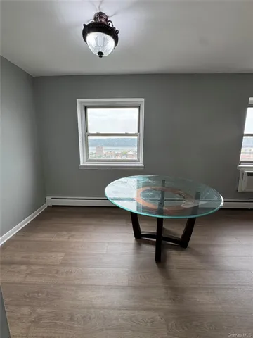 a view of a room with wooden floor and pool table