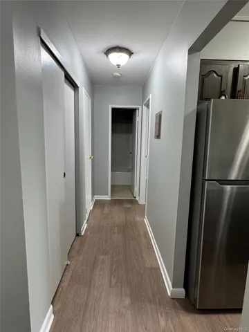 a view of hallway with wooden floor