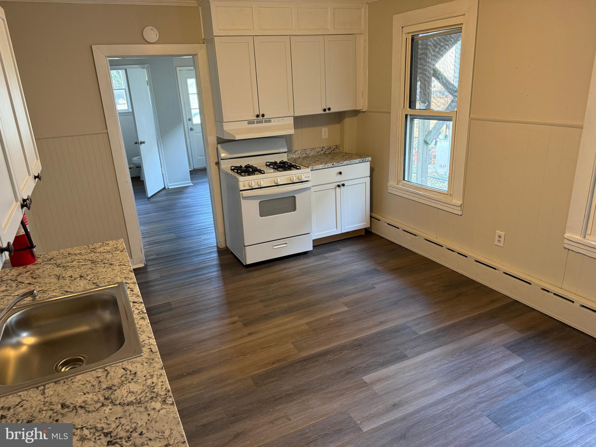 31 Bispham Street, Unit A Mount Holly, NJ 08060 - Photo 4 of 5 a kitchen with wooden floors and white appliances