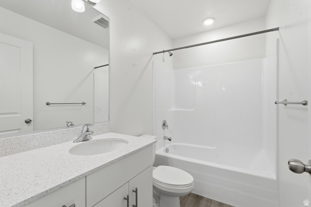 1173 West 1870 South Logan, UT 84321 - Photo 16 of 33 Bathroom featuring a white vanity with a speckled countertop and an undermount sink