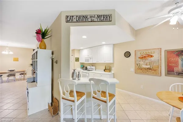 a living room with furniture and a painting on the wall