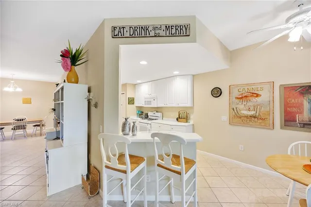 a living room with furniture and a painting on the wall