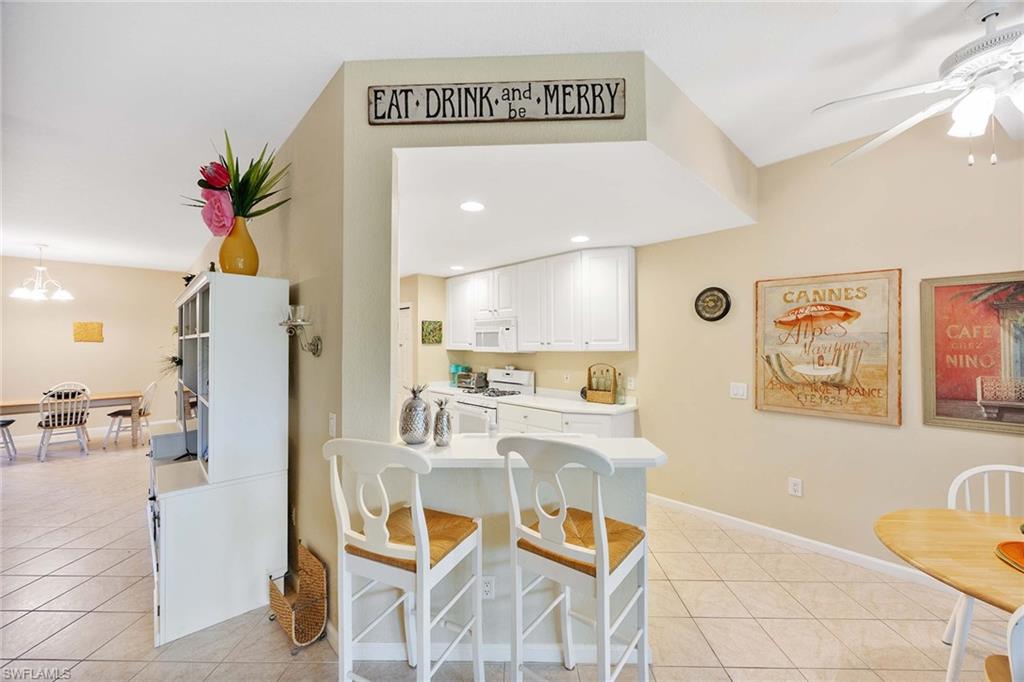 3955 Deer Crossing Court, Unit 103 Naples, FL 34114 - Photo 17 of 40 a living room with furniture and a painting on the wall
