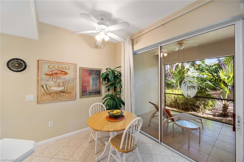 3955 Deer Crossing Court, Unit 103 Naples, FL 34114 - Photo 18 of 40 a dining room with furniture and a large window