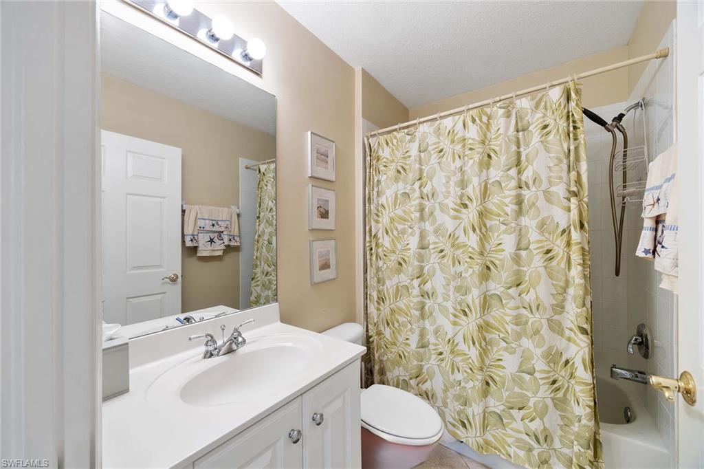 3955 Deer Crossing Court, Unit 103 Naples, FL 34114 - Photo 25 of 40 a bathroom with a sink toilet and shower