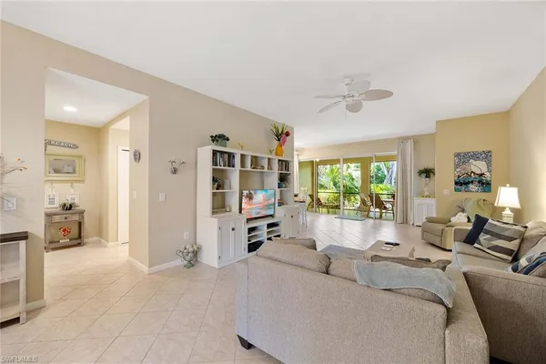 a living room with furniture large window and a flat screen tv