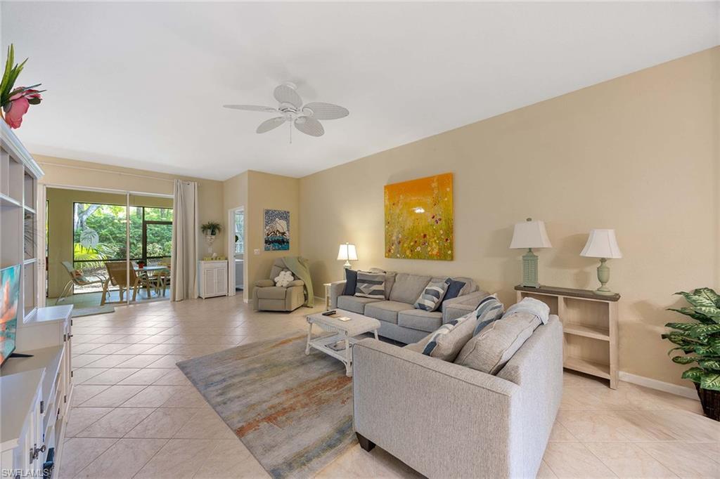 3955 Deer Crossing Court, Unit 103 Naples, FL 34114 - Photo 9 of 40 a living room with furniture and a large window