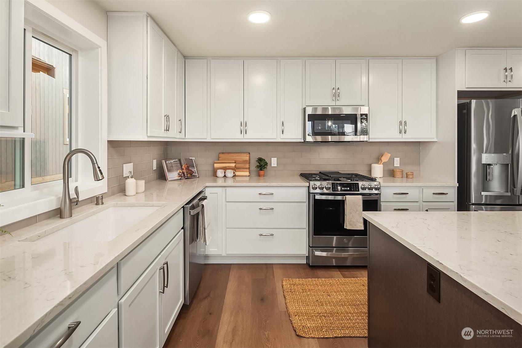 546 Paradise Lane, Unit A202 Edmonds, WA 98020 - Photo 15 of 30 a kitchen with granite countertop white cabinets and stainless steel appliances