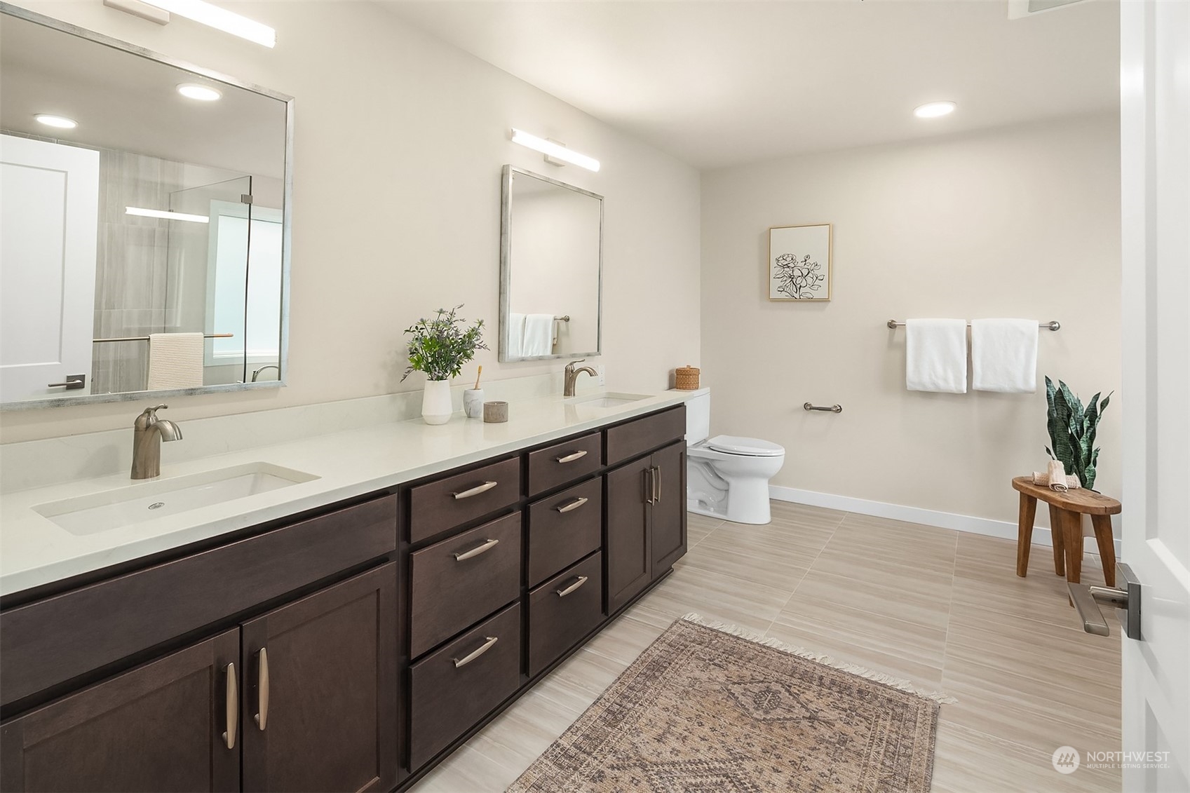 546 Paradise Lane, Unit A202 Edmonds, WA 98020 - Photo 20 of 30 a spacious bathroom with a double vanity sink a toilet and a mirror