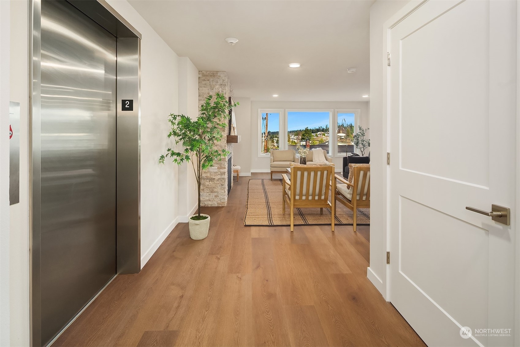 546 Paradise Lane, Unit A202 Edmonds, WA 98020 - Photo 26 of 30 a view of a hallway with wooden floor a glass door and a bathroom