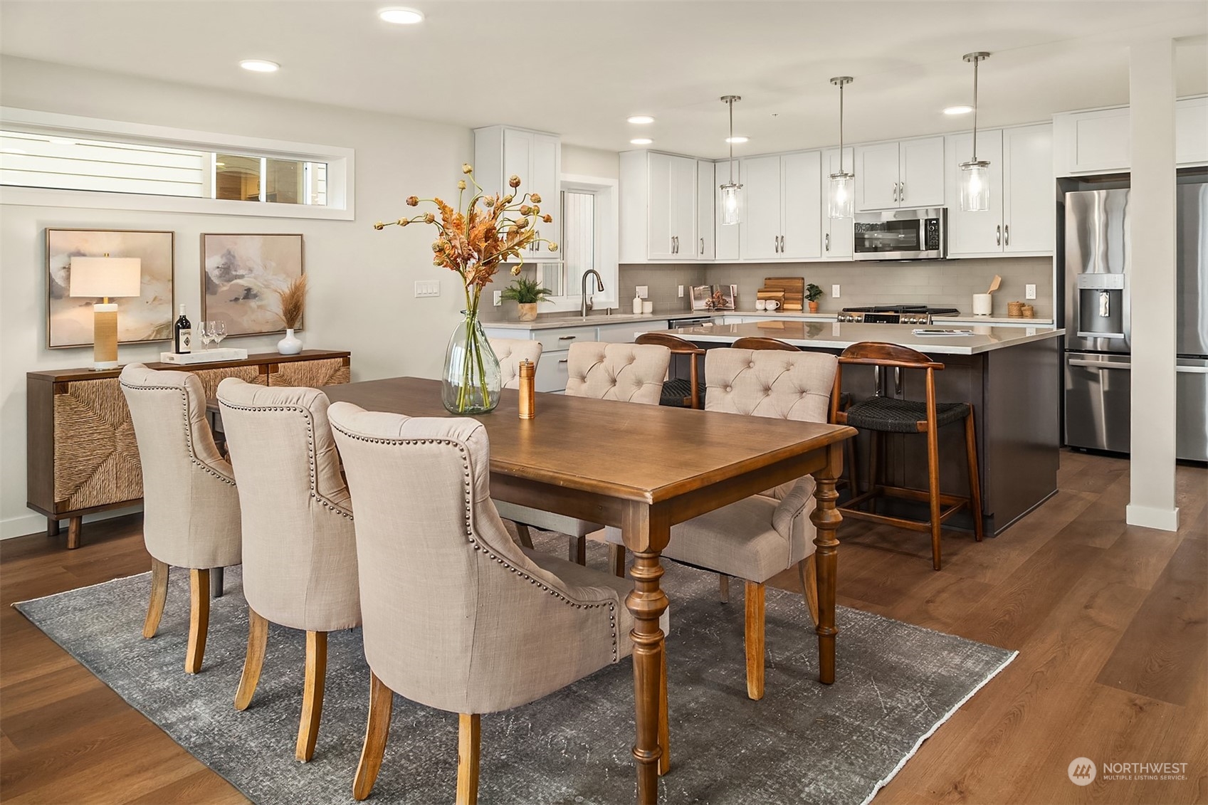 546 Paradise Lane, Unit A202 Edmonds, WA 98020 - Photo 8 of 30 a view of kitchen with refrigerator dining table and chairs