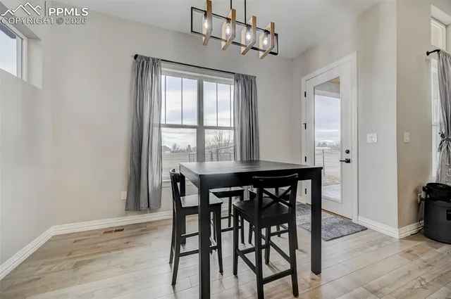 a view of a dining room with furniture window and wooden floor