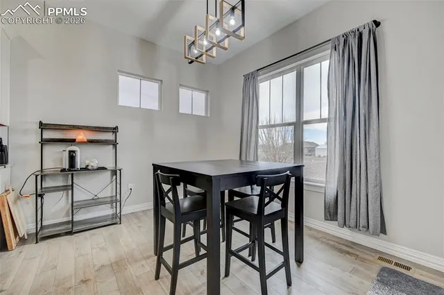 a view of a dining room with furniture window and outside view