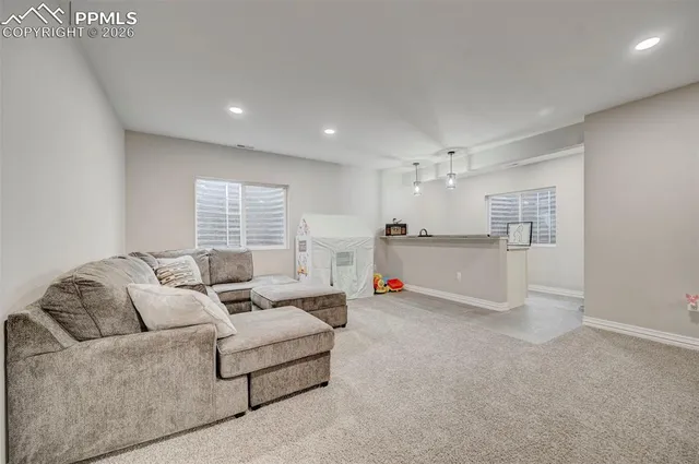 a living room with furniture and a large window